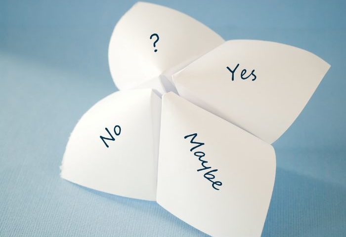 A paper fortune teller with the words "Yes," "No," "Maybe," and a question mark on different flaps, set against a blue background.